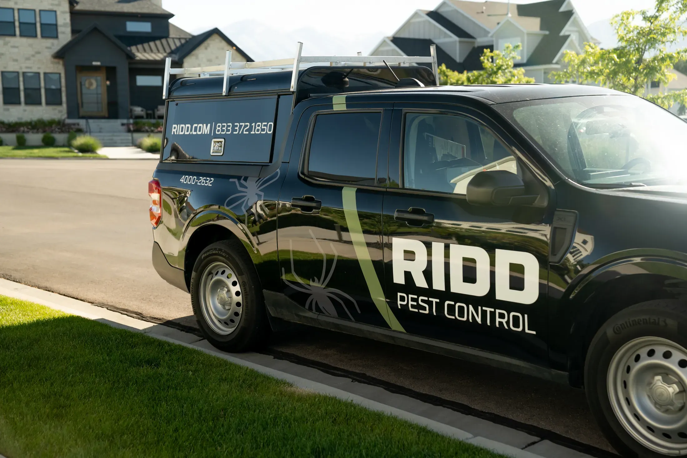 A RIDD service truck parked outside a residential pest control appointment.